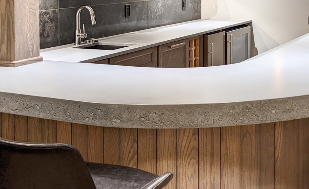 Curved concrete countertops with textured profile.