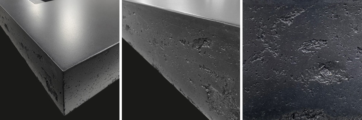 Close up of black concrete sink rough edge.