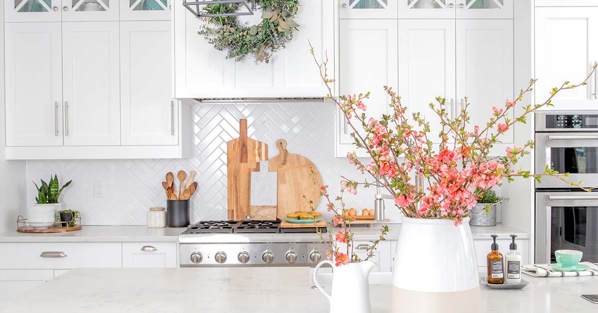 white kitchen with white concrete countertops and backsplash.