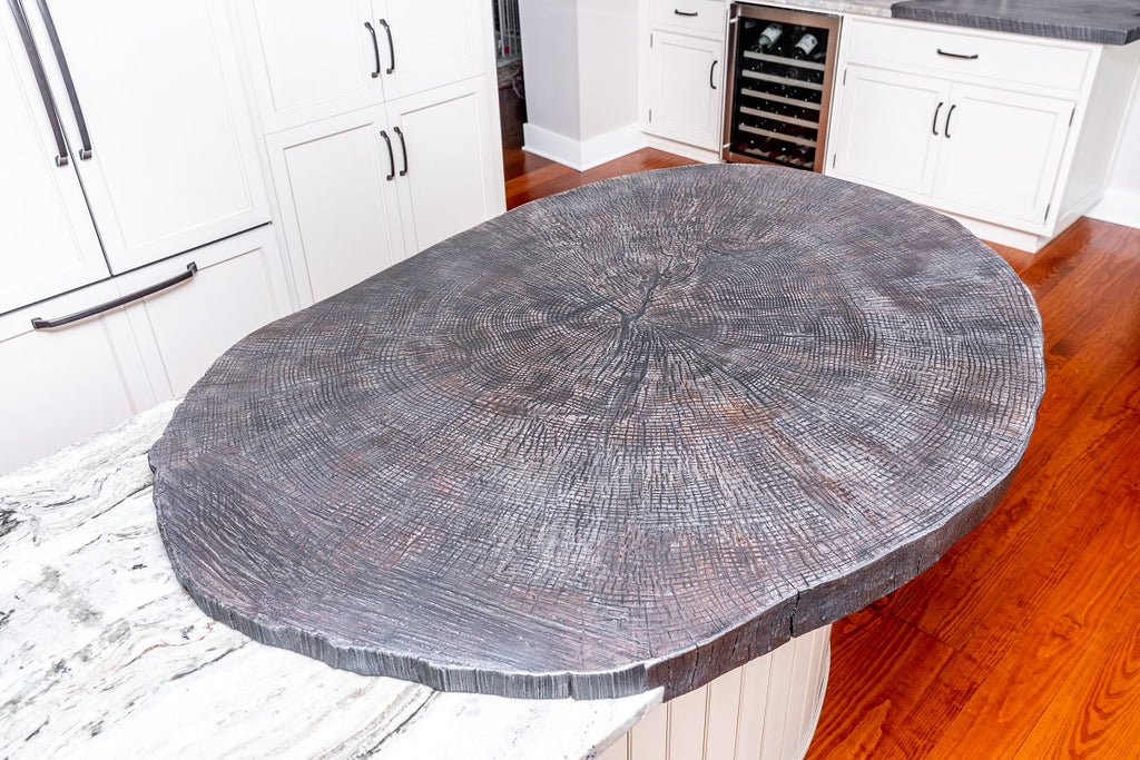 Bright kitchen with slab of wood-look concrete on the countertop.