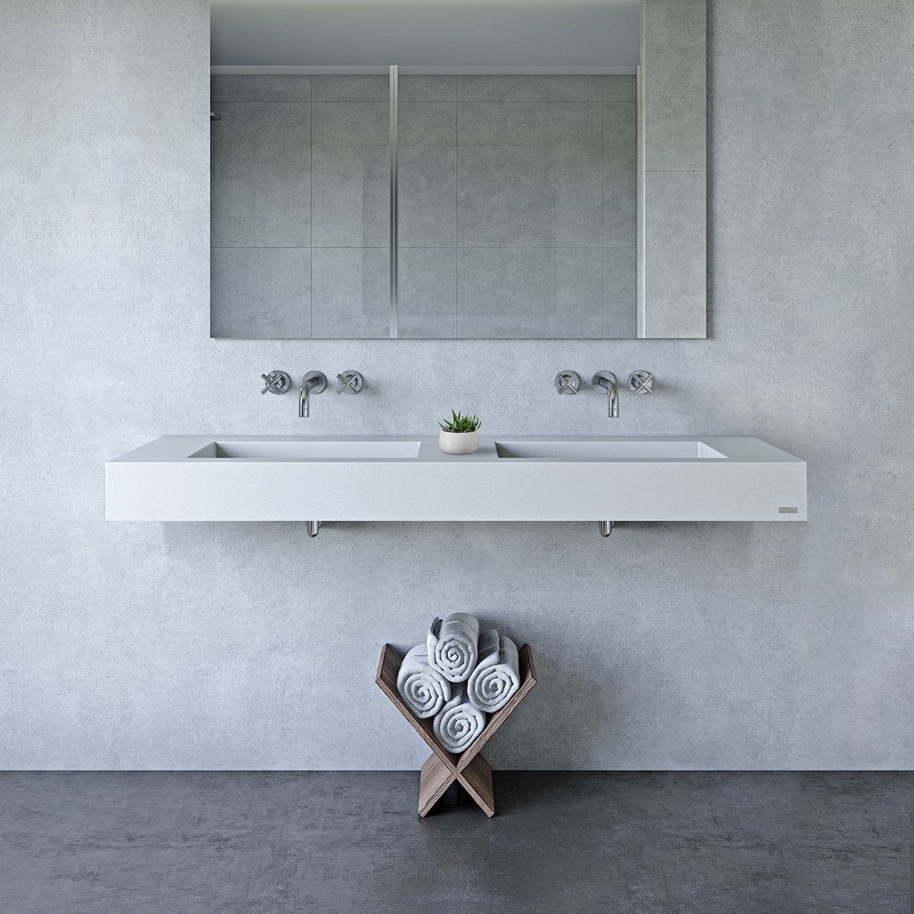 Light gray concrete wall hung sink against a variegated gray wall.