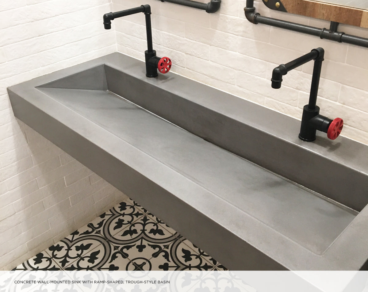 Concrete trough sink with dual faucets in an industrial style.