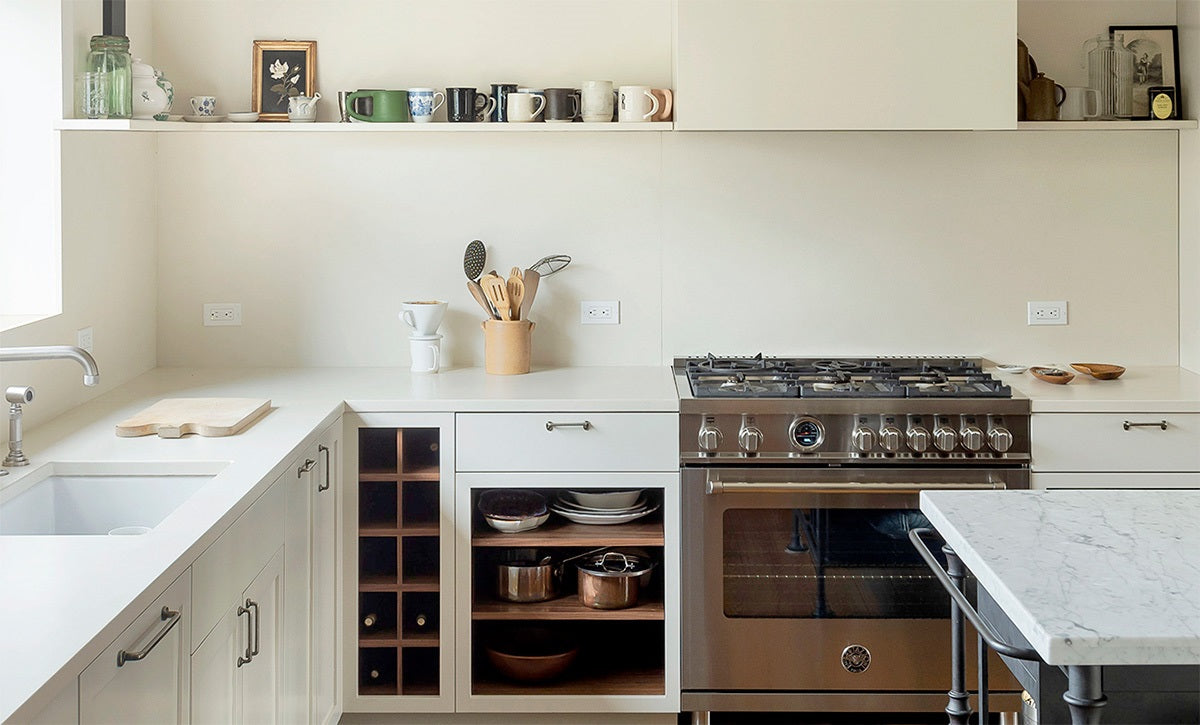 Large white kitchen with white concrete countertops.