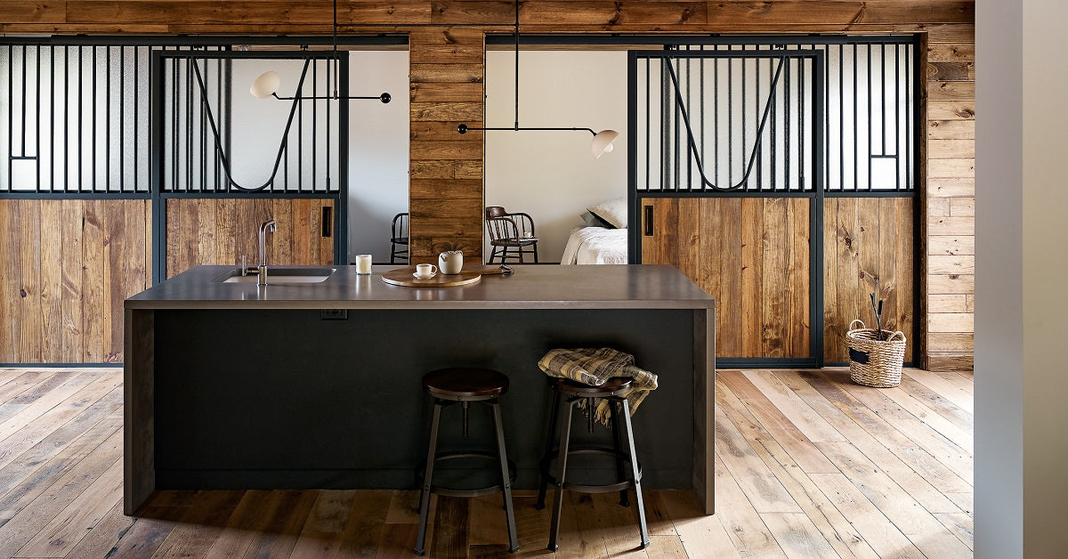 Barn converted into a man cave with concrete, wood, and metal accents.