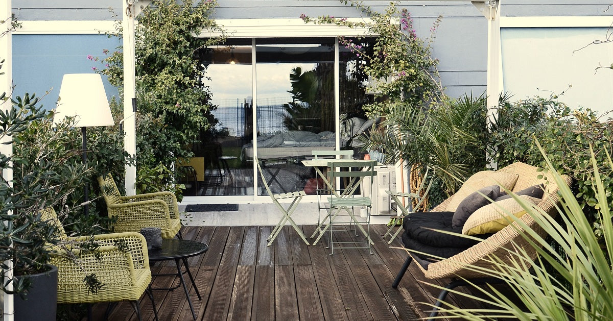 Patio with various chairs, tables, and decor.