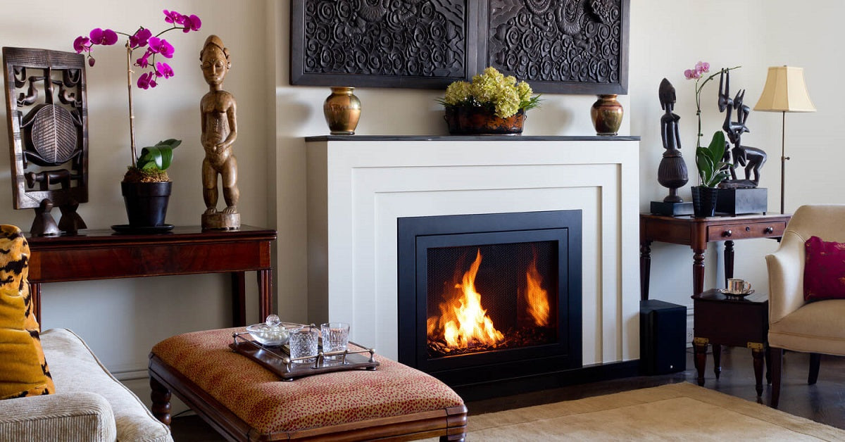 Concrete fireplace surround in a global themed living room.