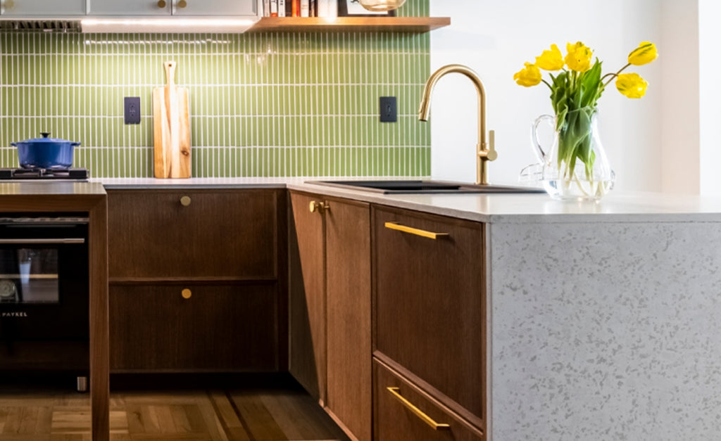 Modern kitchen with textured concrete countertops and green tile backsplash.