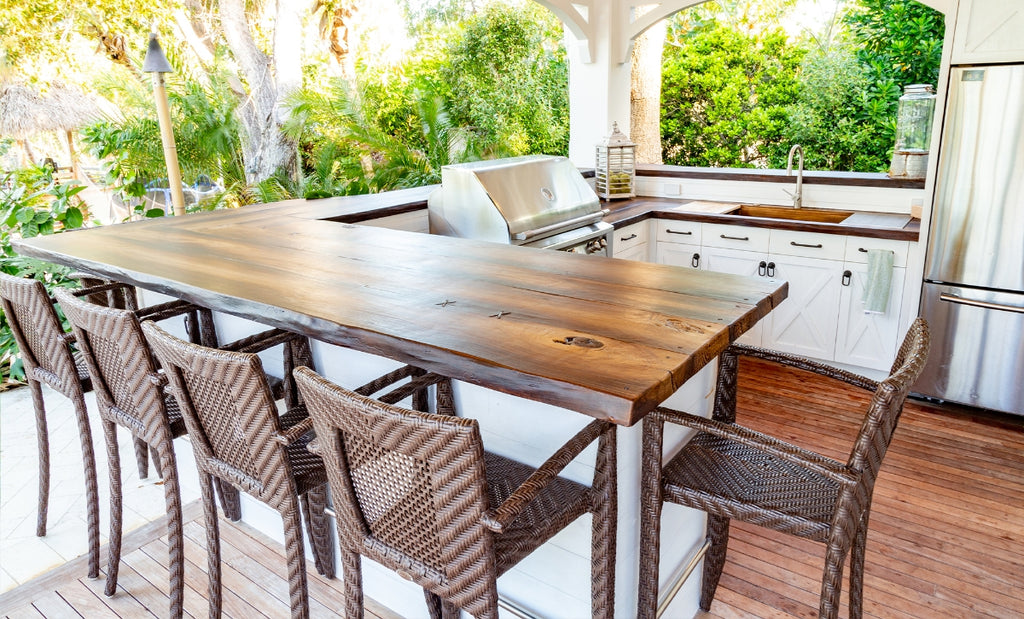Wood look concrete dining table on an outdoor patio.