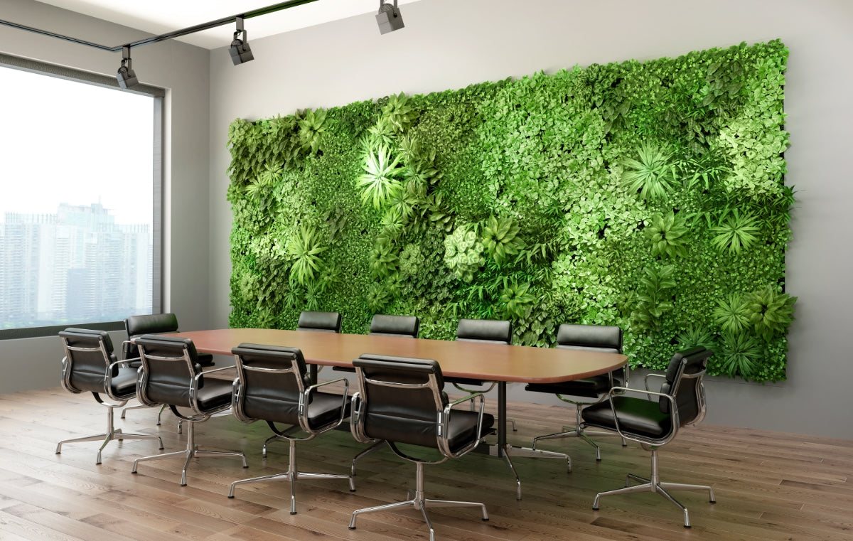 Conference room with green living wall and light wood conference table.