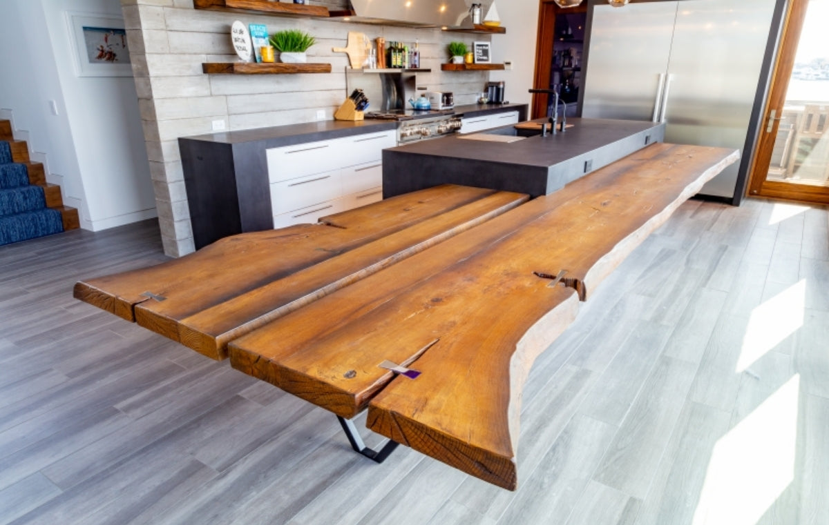 Wood look concrete table in a well appointed kitchen.