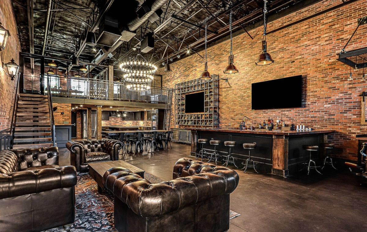 Industrial style interior of a retail store and office with leather, brick, iron, and wood.
