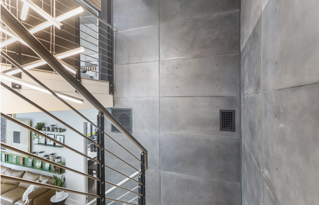Interior stairway in an office building with concrete wall panels.