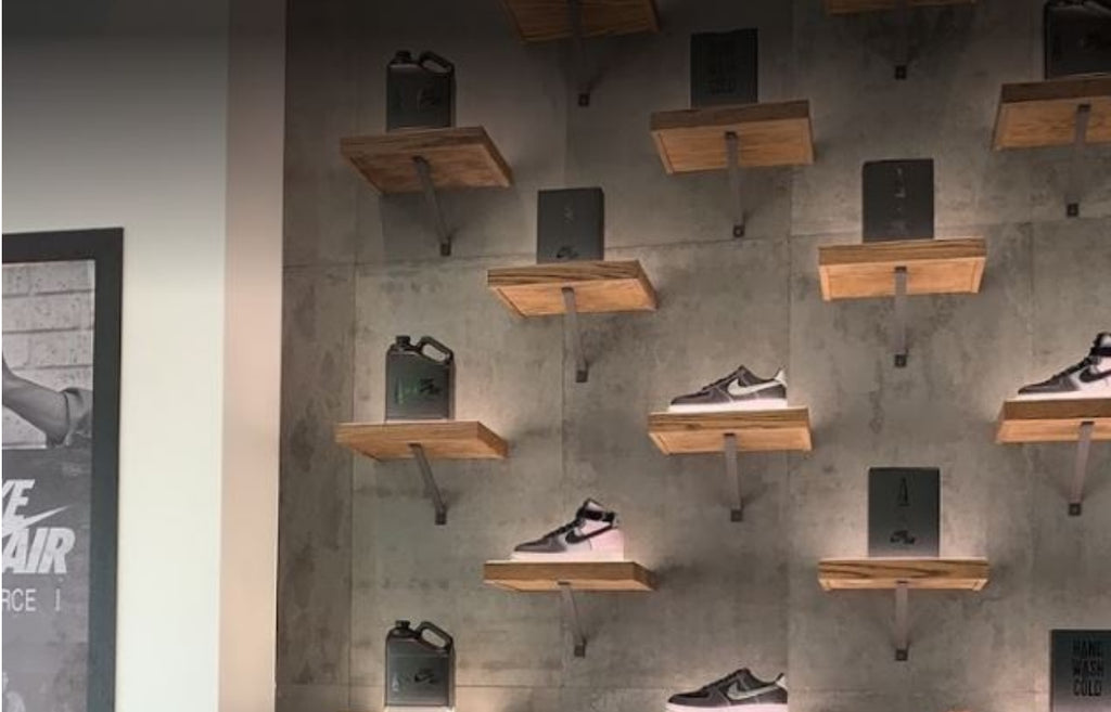 Retail shoe store with concrete panels as the backdrop for displays.