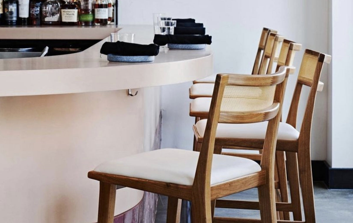 Restaurant bar with beige concrete bar top.