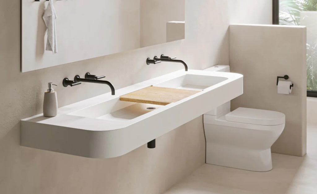 White concrete sink with wood look plank between two trough sinks.