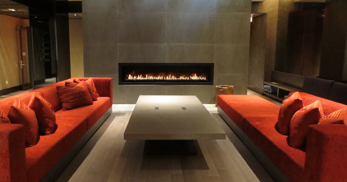 Full wall concrete fireplace.