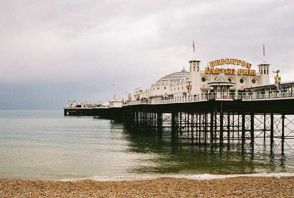 Brighton travel feature. Offie Mag Travel. An image of Brighton and Hove's Pier on a cloudy day.