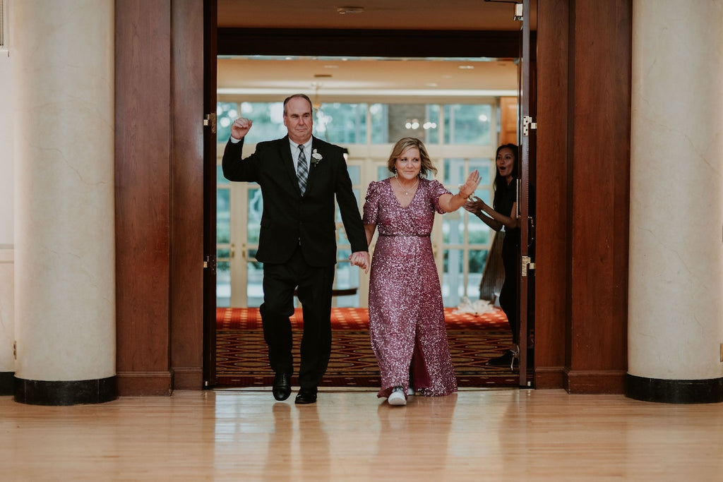 mother and father of the groom enter wedding reception