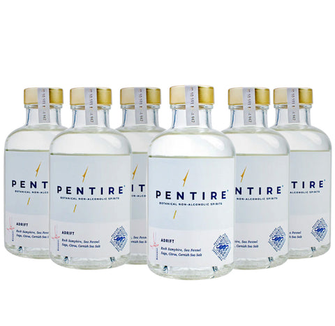 Six bottles of non-alcoholic Pentire Adrift distilled spirit displayed in a triangle against a white background