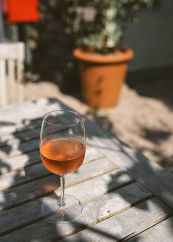 a glass of non-alcoholic drink on a wooden table