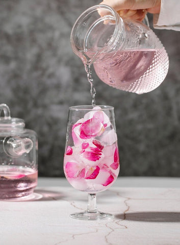 non-alcoholic rose mojito in an ice and rose petal-filled glass
