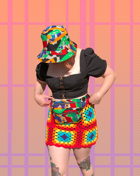 Steph wears the pop art cow print bucket hat and bumbag. Bumbag is being worn around her waist