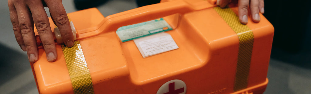 image of a hand locking a first aid box