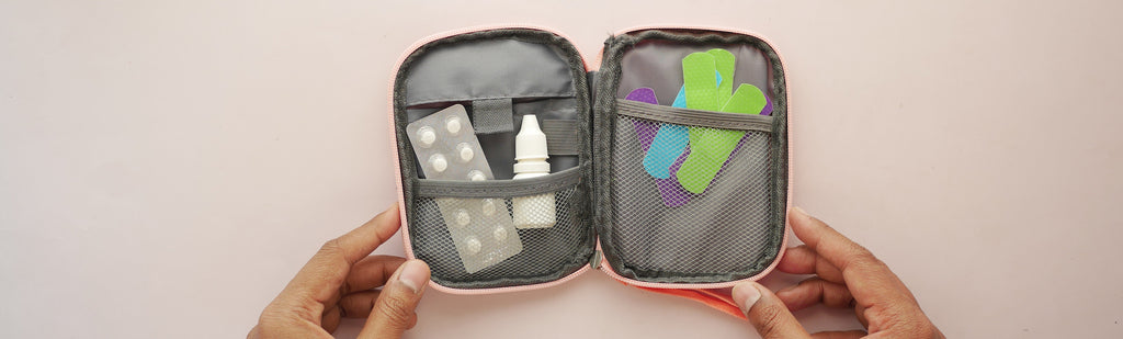 Image of a hand opening a first aid kit