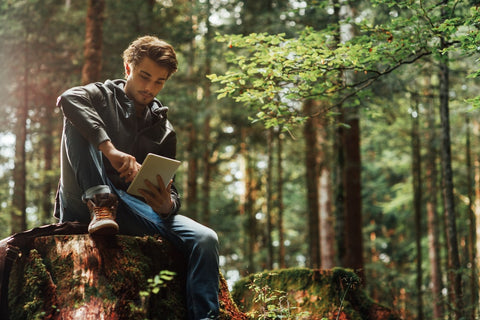 Young man reading in nature