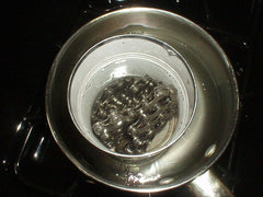 Waxing a chain in a double boiler