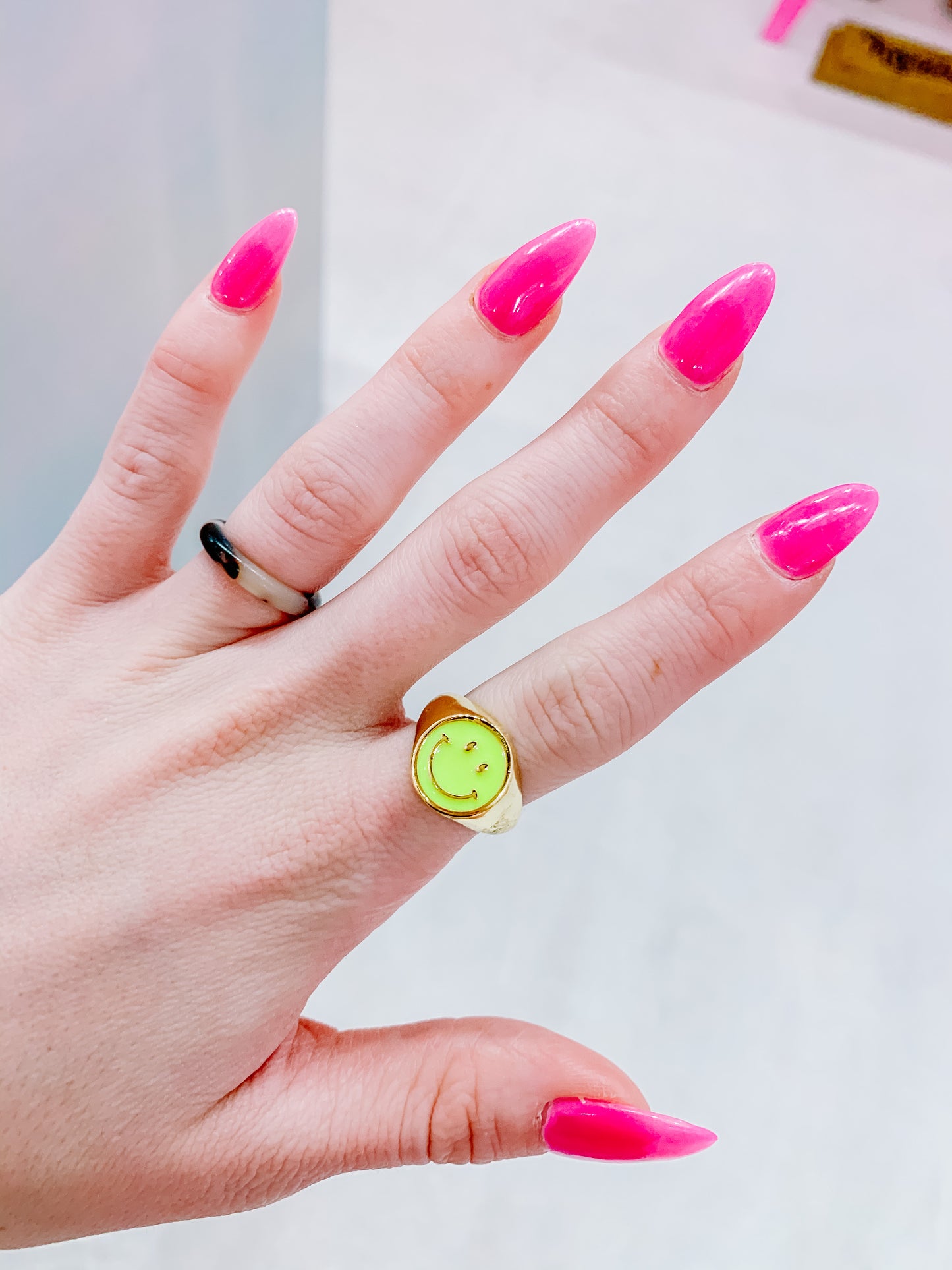 Neon yellow smiley face signet ring.