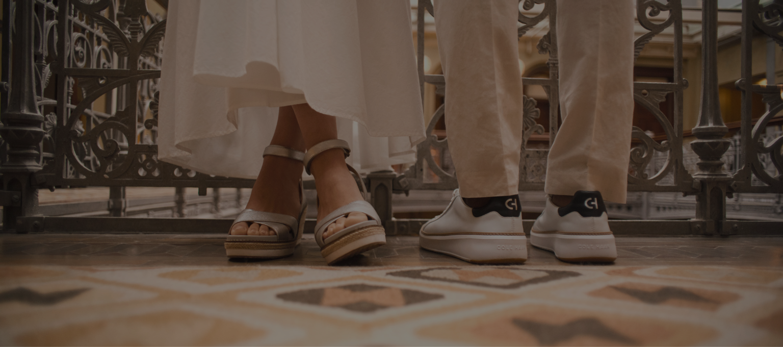 Man and woman standing wearing cole haan shoes