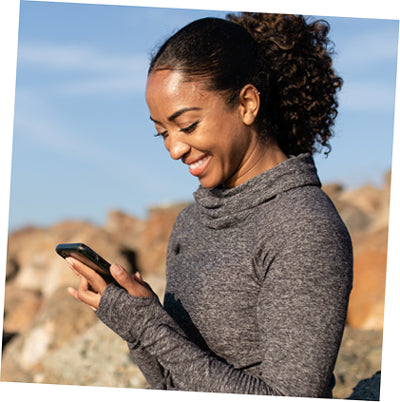 woman looking at phone screen and smiling Beauty Of The Nile