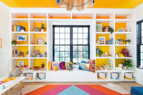 kids bedroom storage shelves with toys surrounding a large window