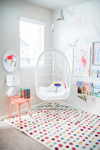 kids bedroom with round swing hanging chair and rug