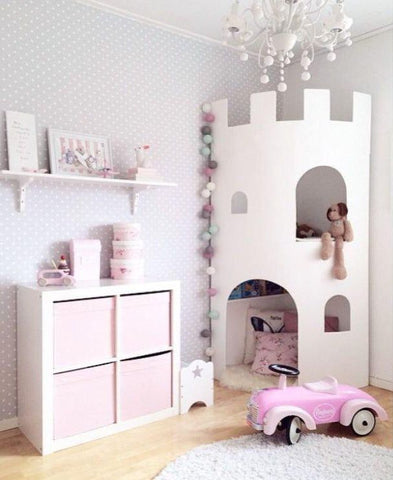 pink and pastel princess castle themed playroom with toy car and shelves