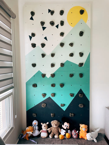 Lil Boulder kids indoor climbing wall with mountain mural and kids crash pad with toys