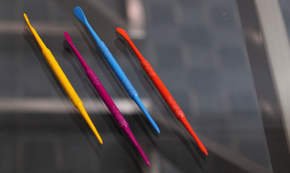 Colored Dab Tools resting on a glass surface