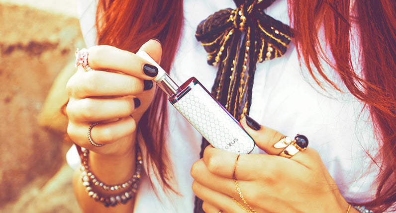 Woman with white shirt holding Unicorn Exxus MiNovo pulling out cartridge.