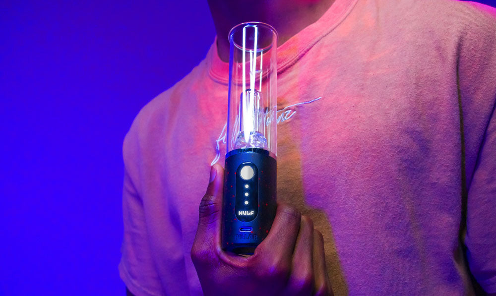 Man holding Wulf Mods Pillar under blue and purple studio lighting