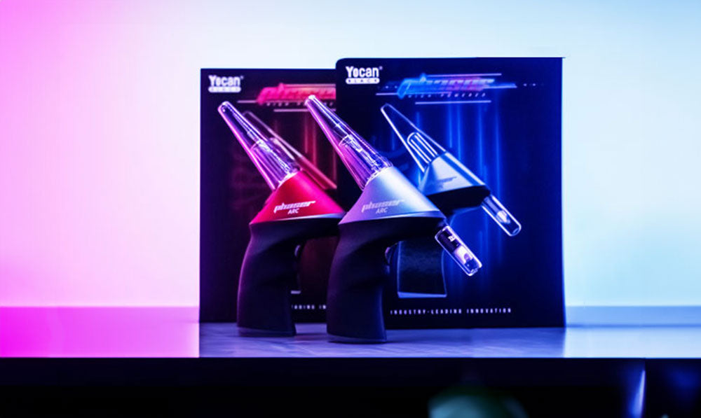 Yocan Phaser Nectar Collector standing on black counter with purple lighting