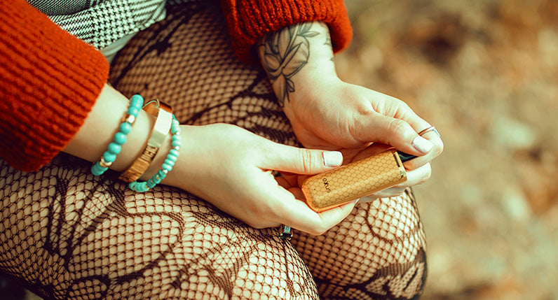 Woman in red sweater sitting and holding the Gold Cobra Exxus MiNovo