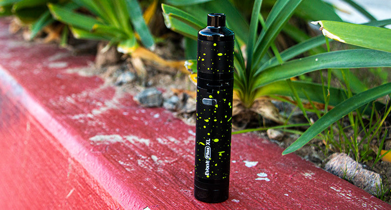 Black and Green Spatter Evolve Plus XL standing outside on curb