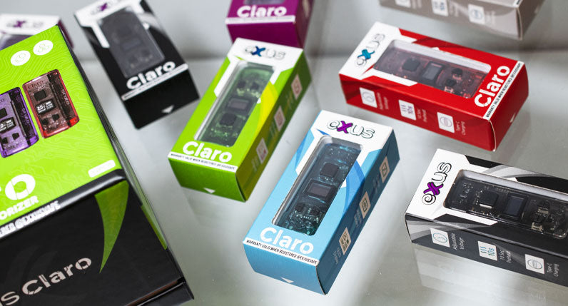 Exxus Claro units resting on white display with packaging nearby