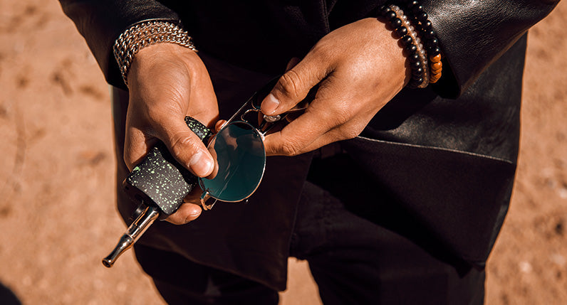 Man with sunglasses holding the Exxus Push at desert