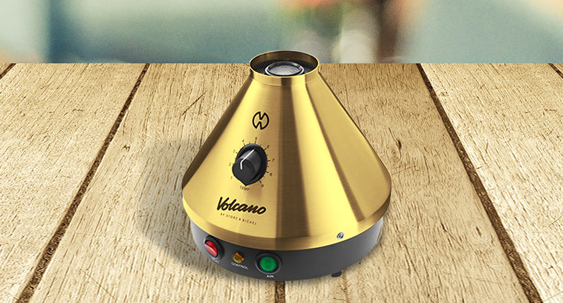 Classic Volcano Gold Edition standing on wooden table inside house.