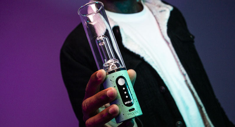 Man holding Wulf Mods Pillar under purple and blue studio lighting