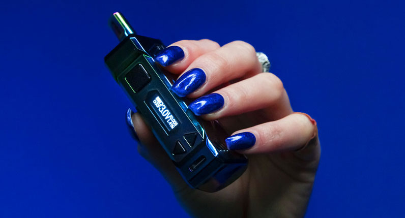 Woman holding Wulf UNI Pro Max in front of blue studio background