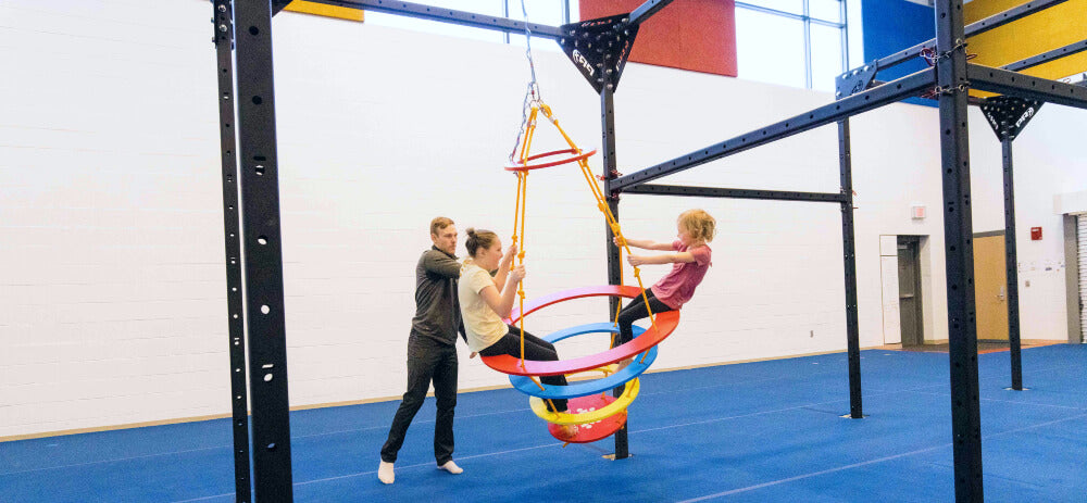 two girls riding on a Sensory SwRing