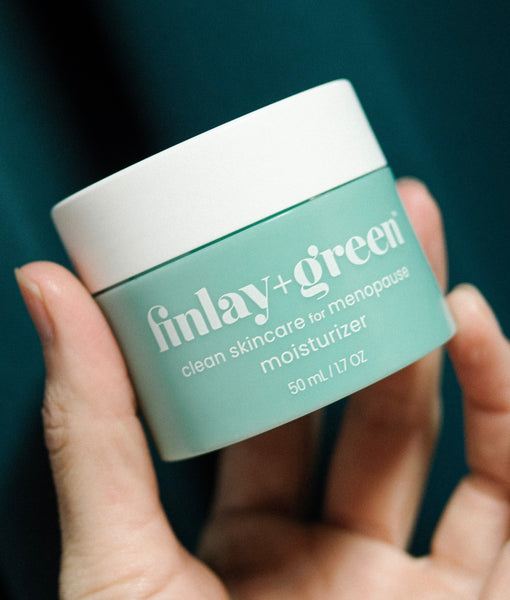 Woman holding the Finlay+Green clean moisturizer